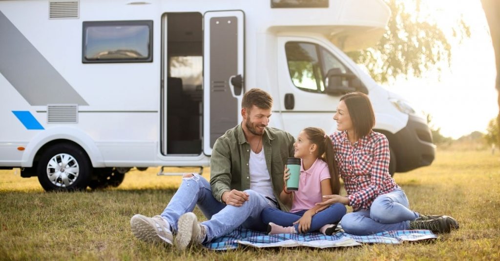 A family enjoying their camping expedition with their recreational vehicle. 